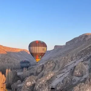 Balloon over rock formations on Soğanlı Flight Cappadocia.