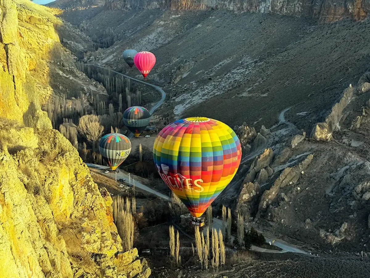 Colorful balloons floating through Soganli valley in Cappadocia