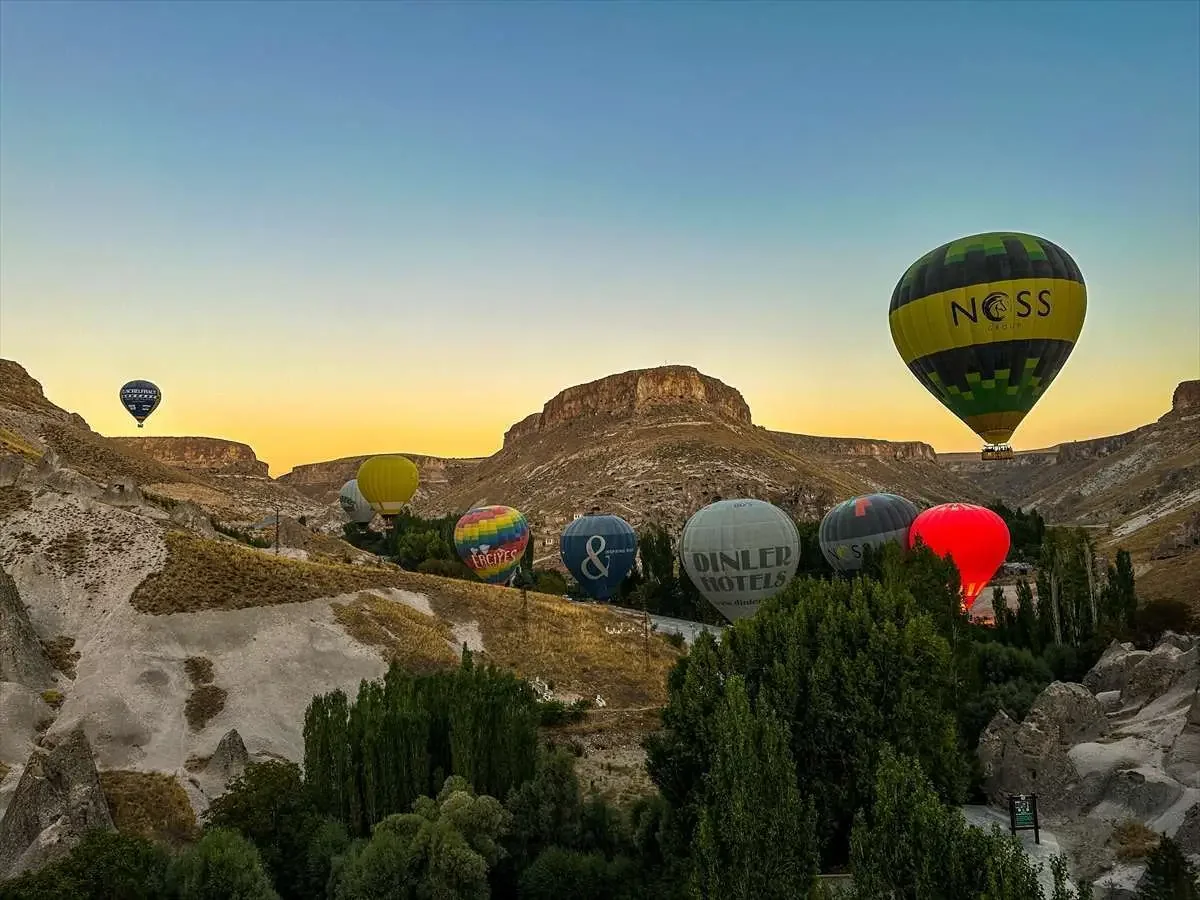 Hot air balloons between Soganli valley rock formations in Cappadocia