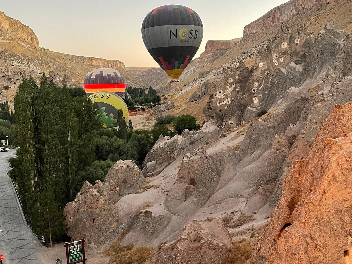 Hot air balloons flying through Soganli valley canyon in Cappadocia