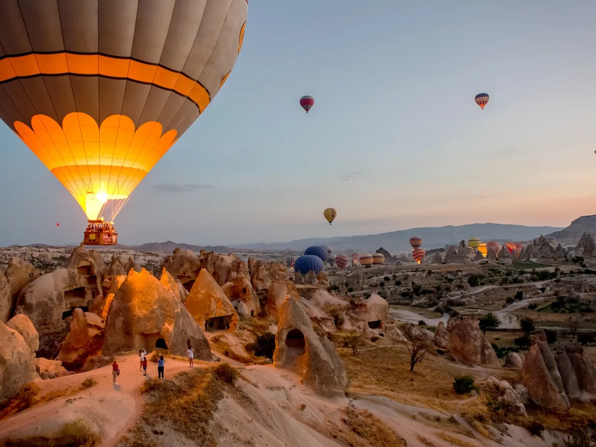 Beautiful hot air balloon glowing above Cappadocia caves