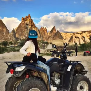 Traveler posing with an ATV during a daytime tour among Cappadocia valleys