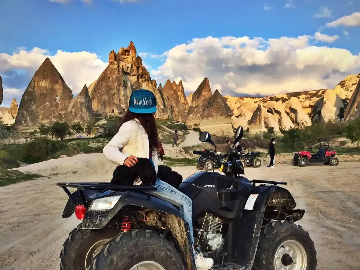 Traveler posing with an ATV during a daytime tour among Cappadocia valleys