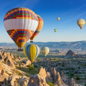 Colorful hot air balloons flying above Cat Valley in Cappadocia at sunrise