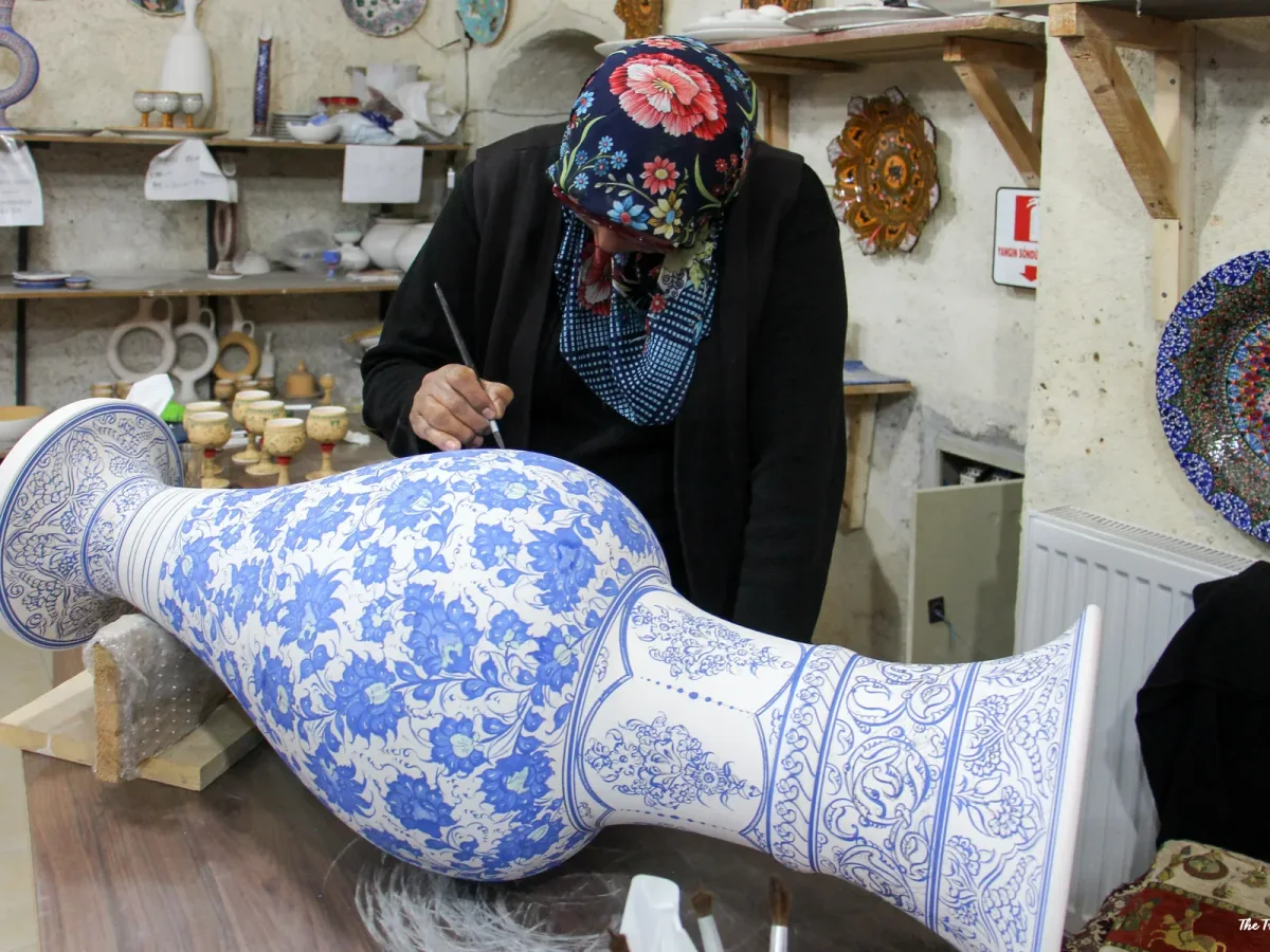 Ceramic artisan painting a traditional vase in Avanos during the Cappadocia Eco Red Tour