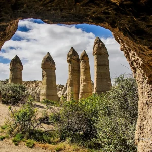 Love Valley fairy chimneys viewed through a cave opening in Cappadocia