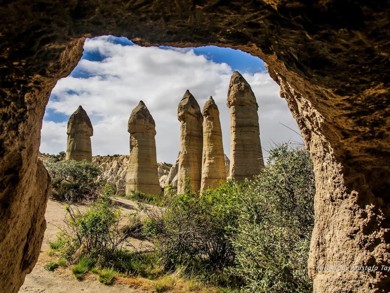 Love Valley fairy chimneys viewed through a cave opening in Cappadocia