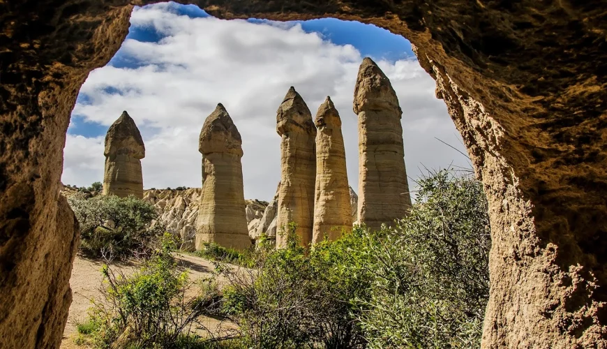 Love Valley fairy chimneys viewed through a cave opening in Cappadocia
