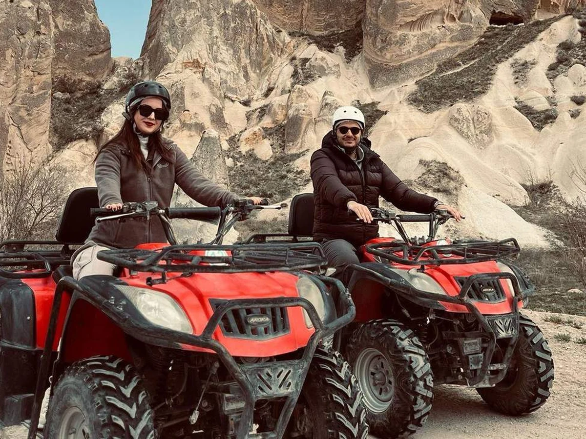 Two travelers on red quad bikes during a Cappadocia adventure