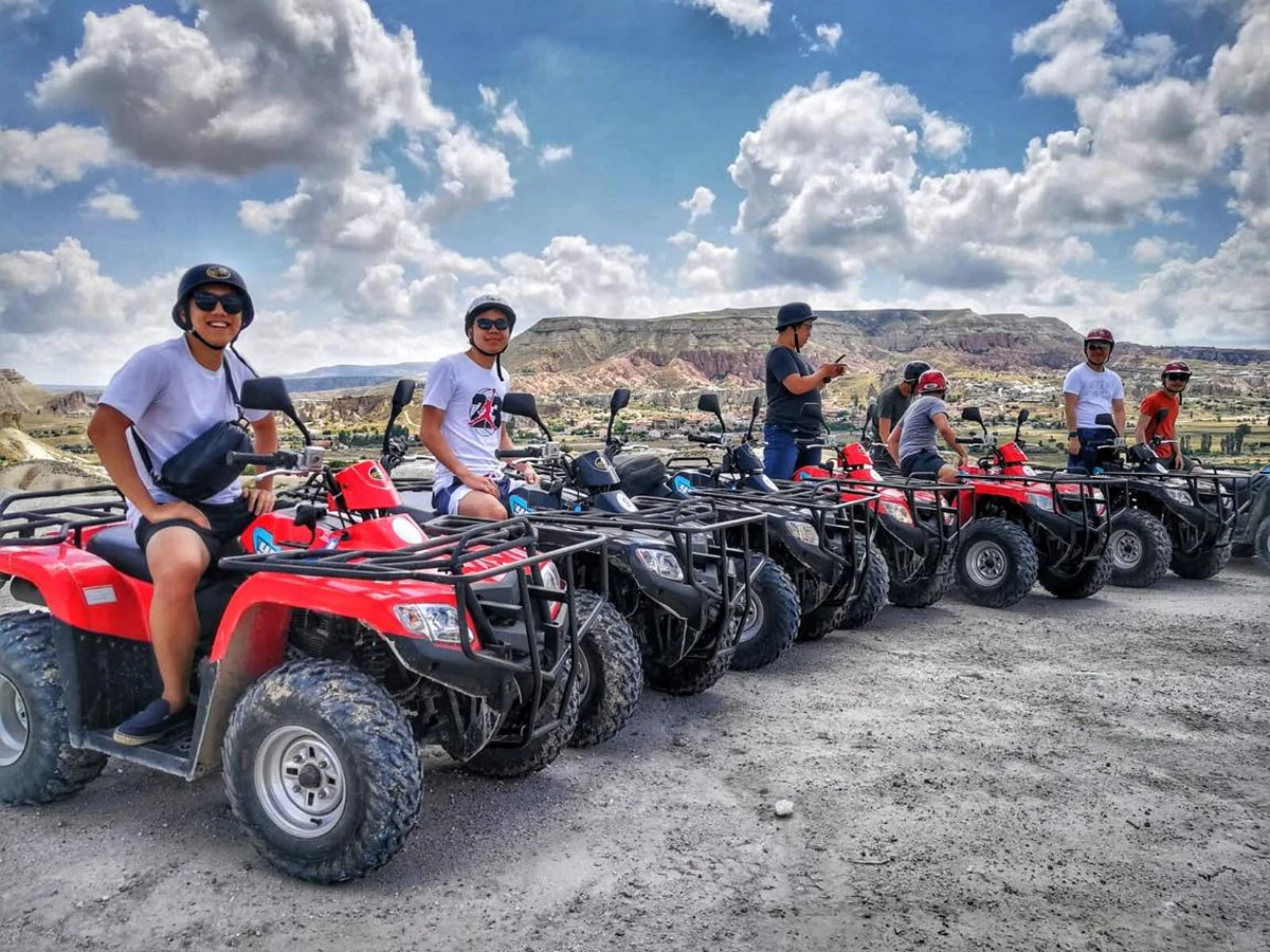 Quad bike tour group posing together in a Cappadocia valley