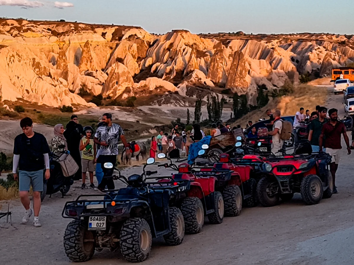 ATV group lined up at a scenic Cappadocia valley during the sunset tour
