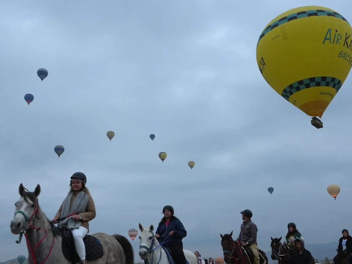 Travelers enjoying a guided horseback tour in Cappadocia at sunrise