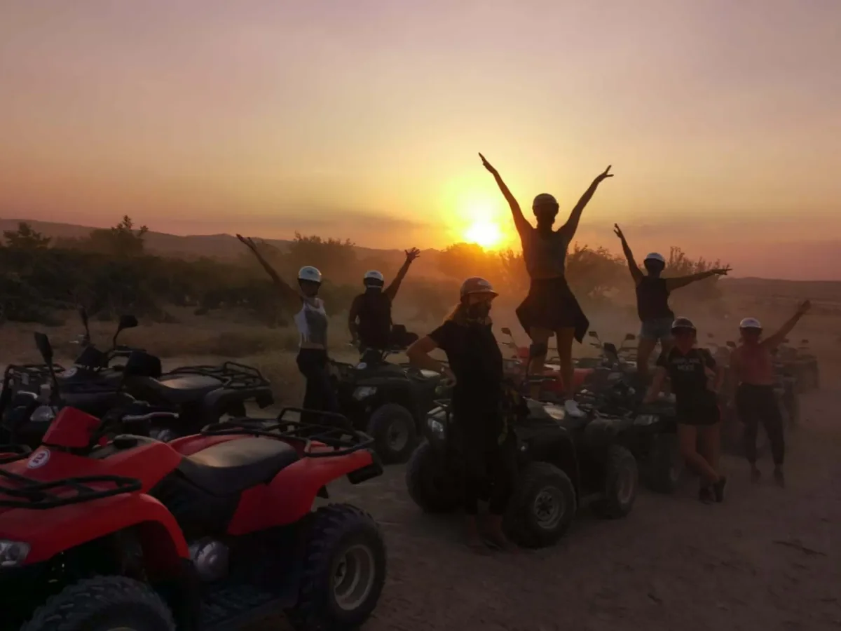 ATV tour guests celebrating at a Cappadocia sunset viewpoint