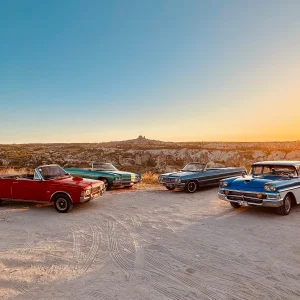 Classic convertible cars lined up during a Cappadocia sunset vintage car tour