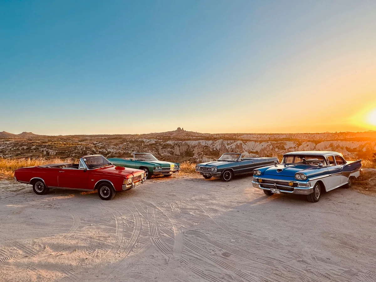 Classic convertible cars lined up during a Cappadocia sunset vintage car tour