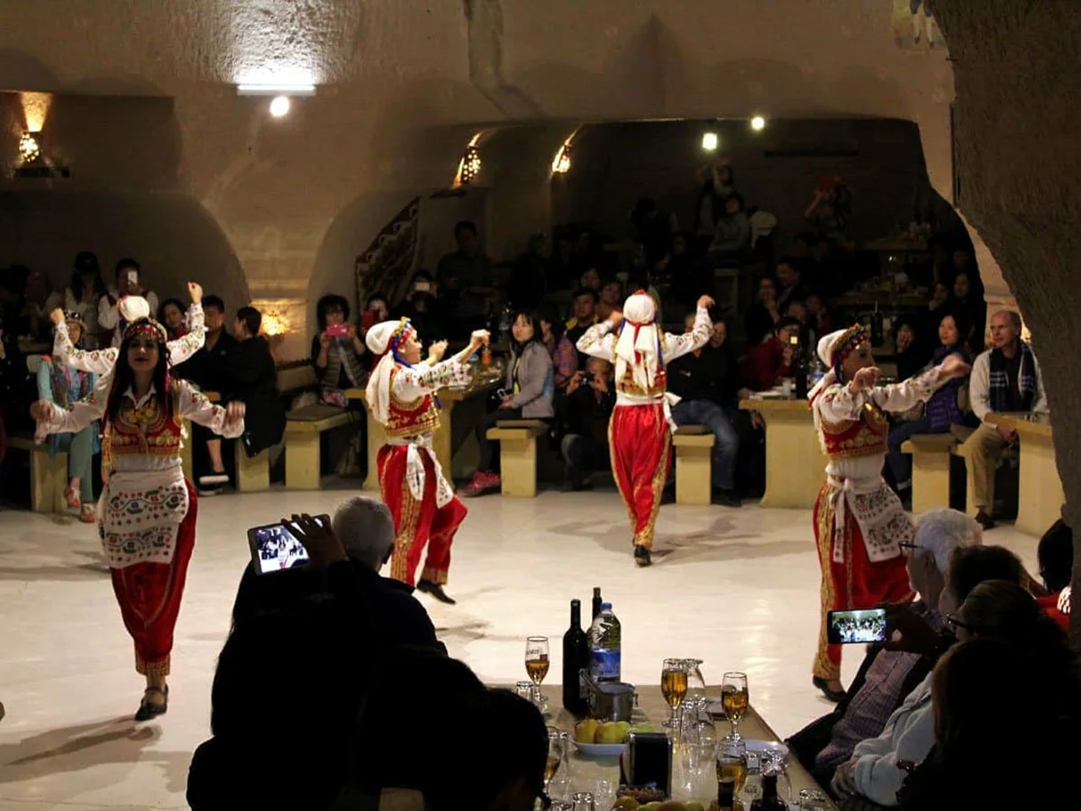Group of folk dancers performing for guests at a Cappadocia Turkish Night Show