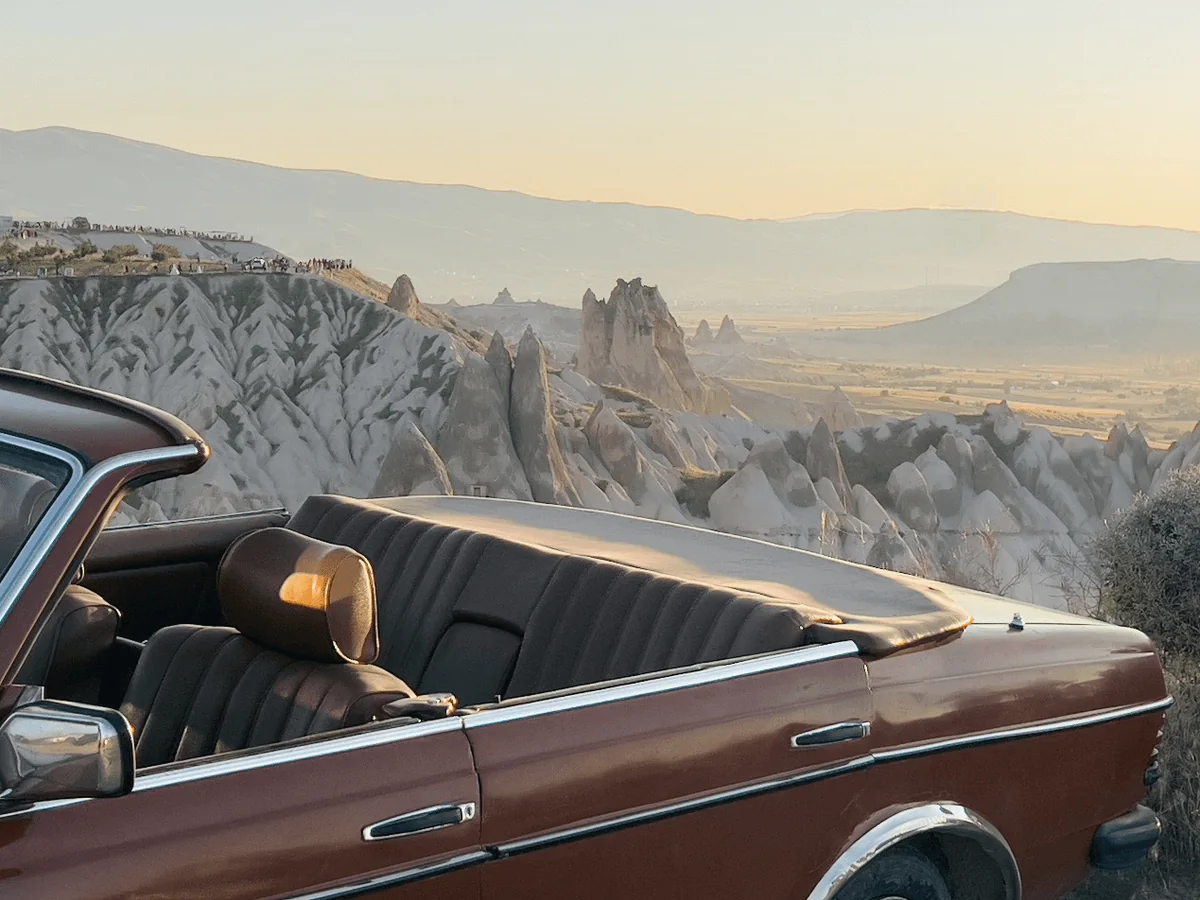 Vintage convertible overlooking the Cappadocia valleys during a daytime tour