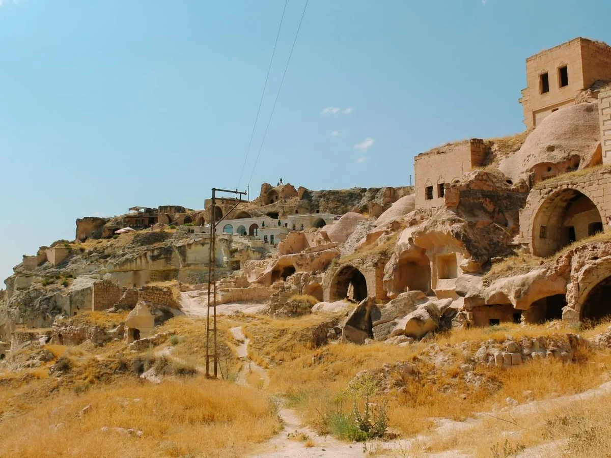 Historic cave houses and walking path in Cavusin Old Village on a private Cappadocia Red Tour