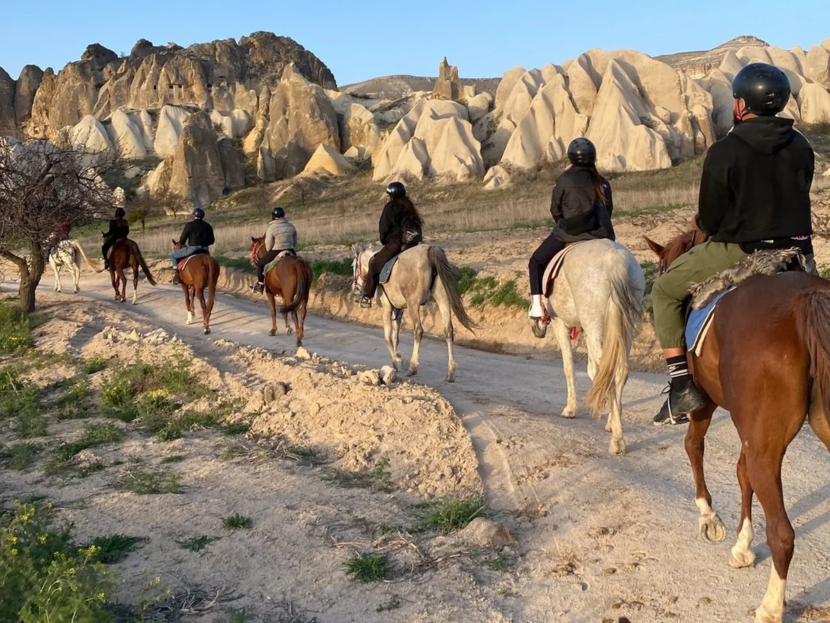 Horse riders following a scenic daytime trail through a Cappadocia valley