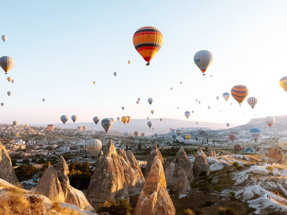 Floating hot air balloons above Cappadocia rock caves