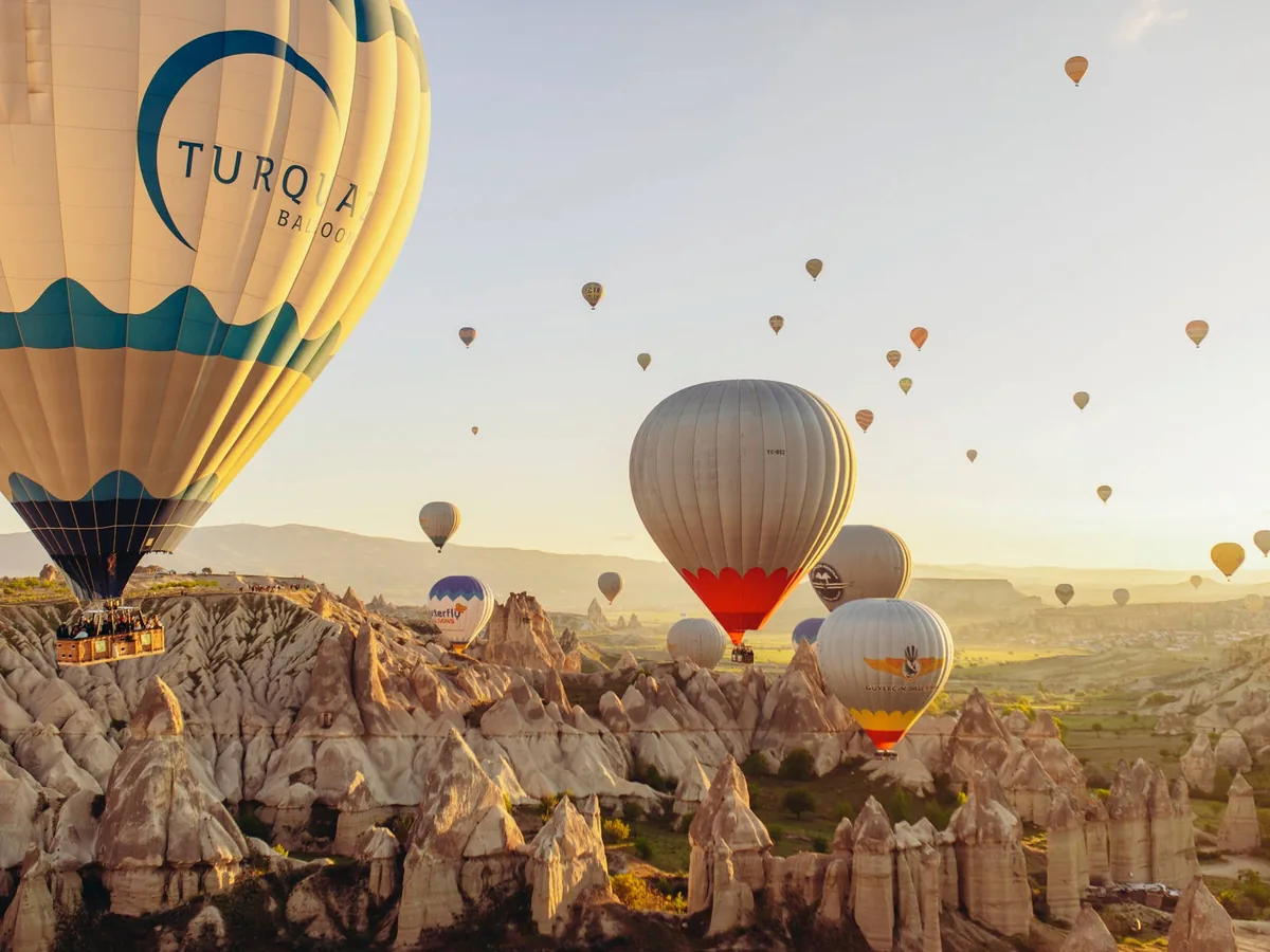Floating hot air balloons above Cappadocia caves
