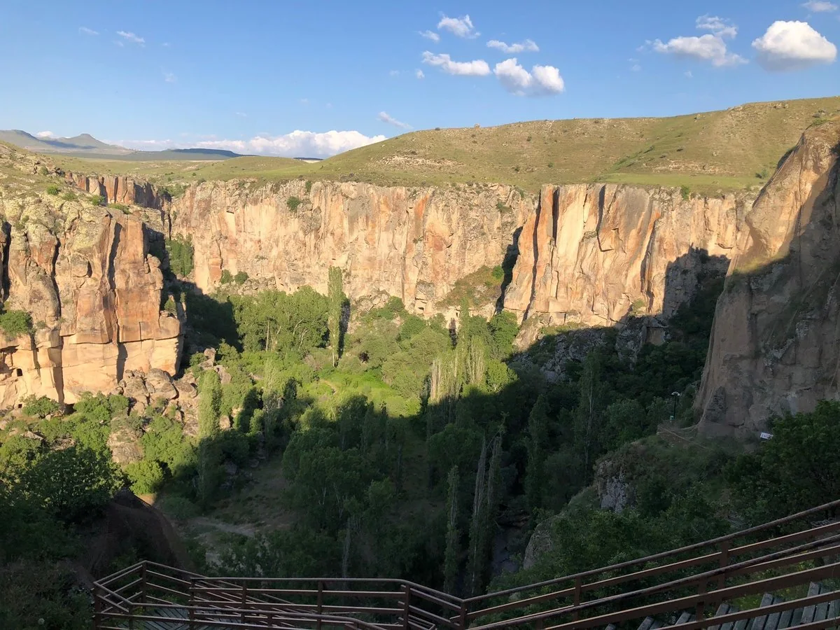 Green canyon and towering rock cliffs in Ihlara Valley, Cappadocia