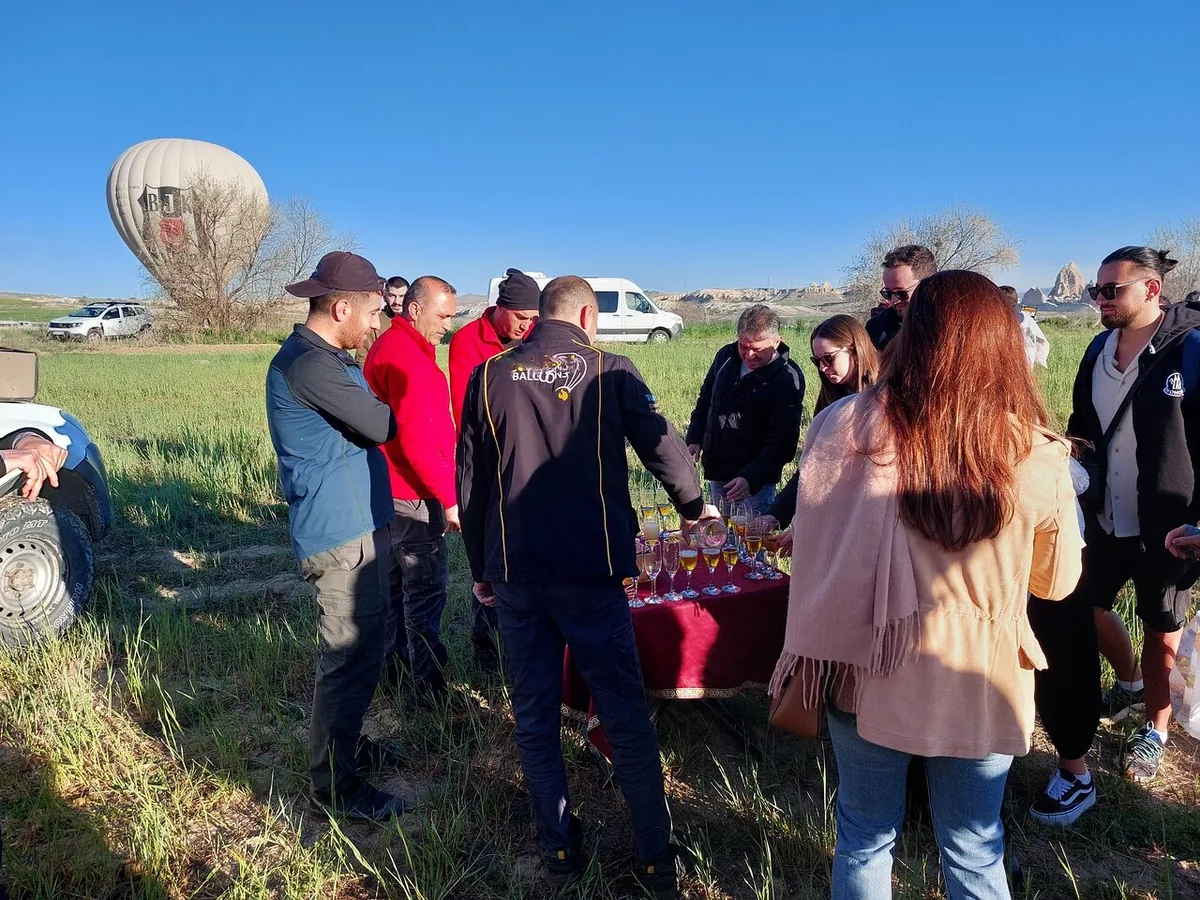 Guests gathering for champagne after hot air balloon landing in Cappadocia