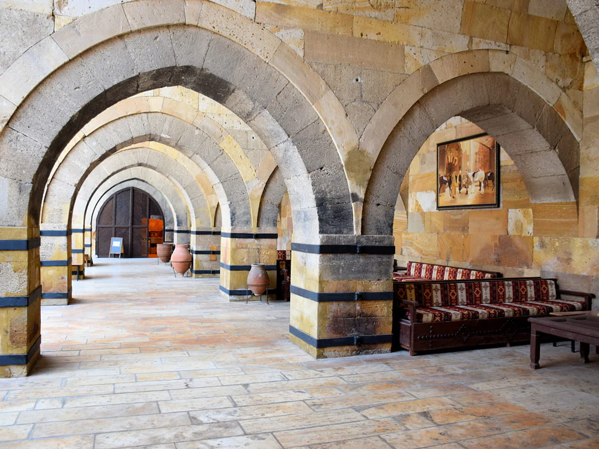 Stone archways and seating inside a historic Cappadocia caravanserai