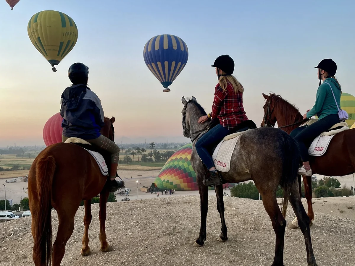 Horseback riders exploring Cappadocia landscapes in the early morning light