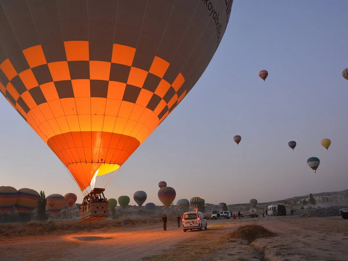 Hot air balloon takeoff before sunrise in Cappadocia