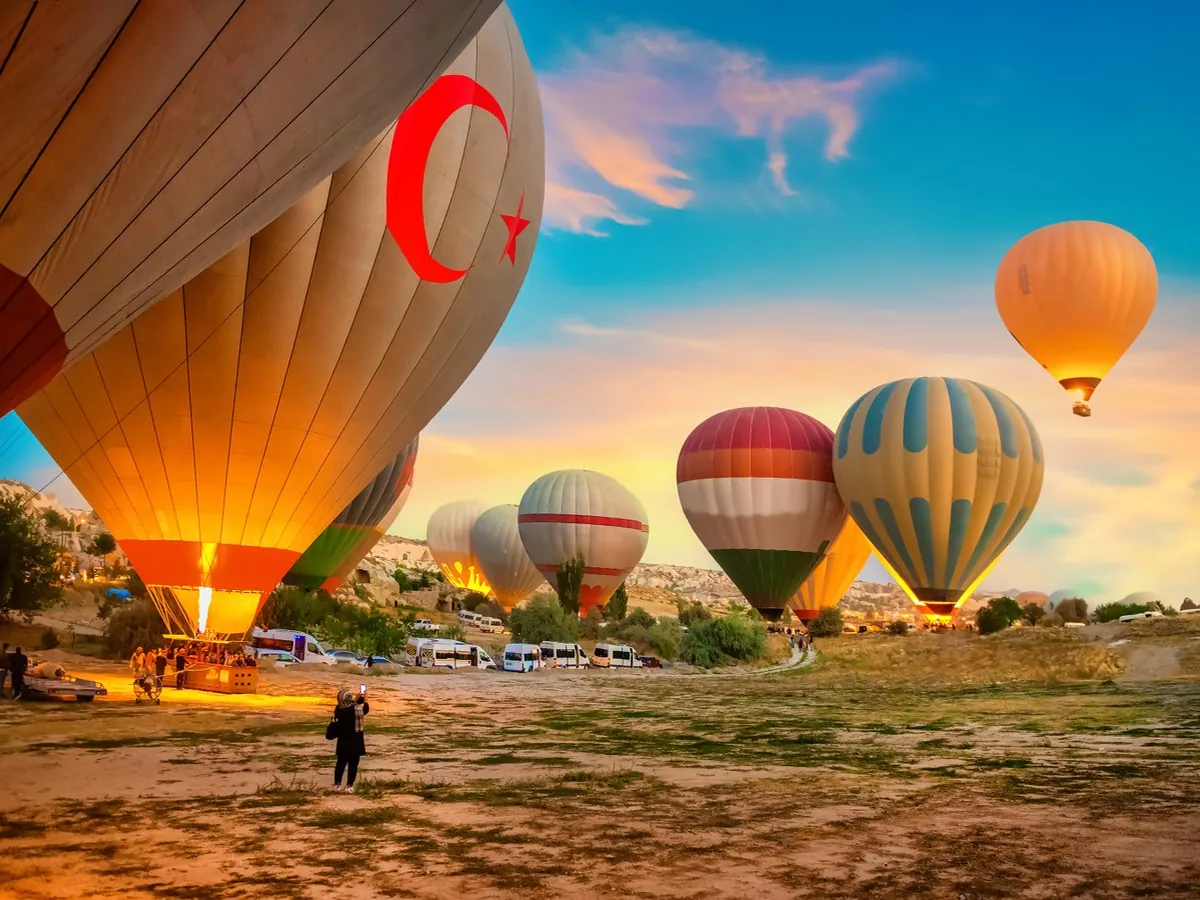 Hot air balloon takeoff with Cappadocia sunrise sky