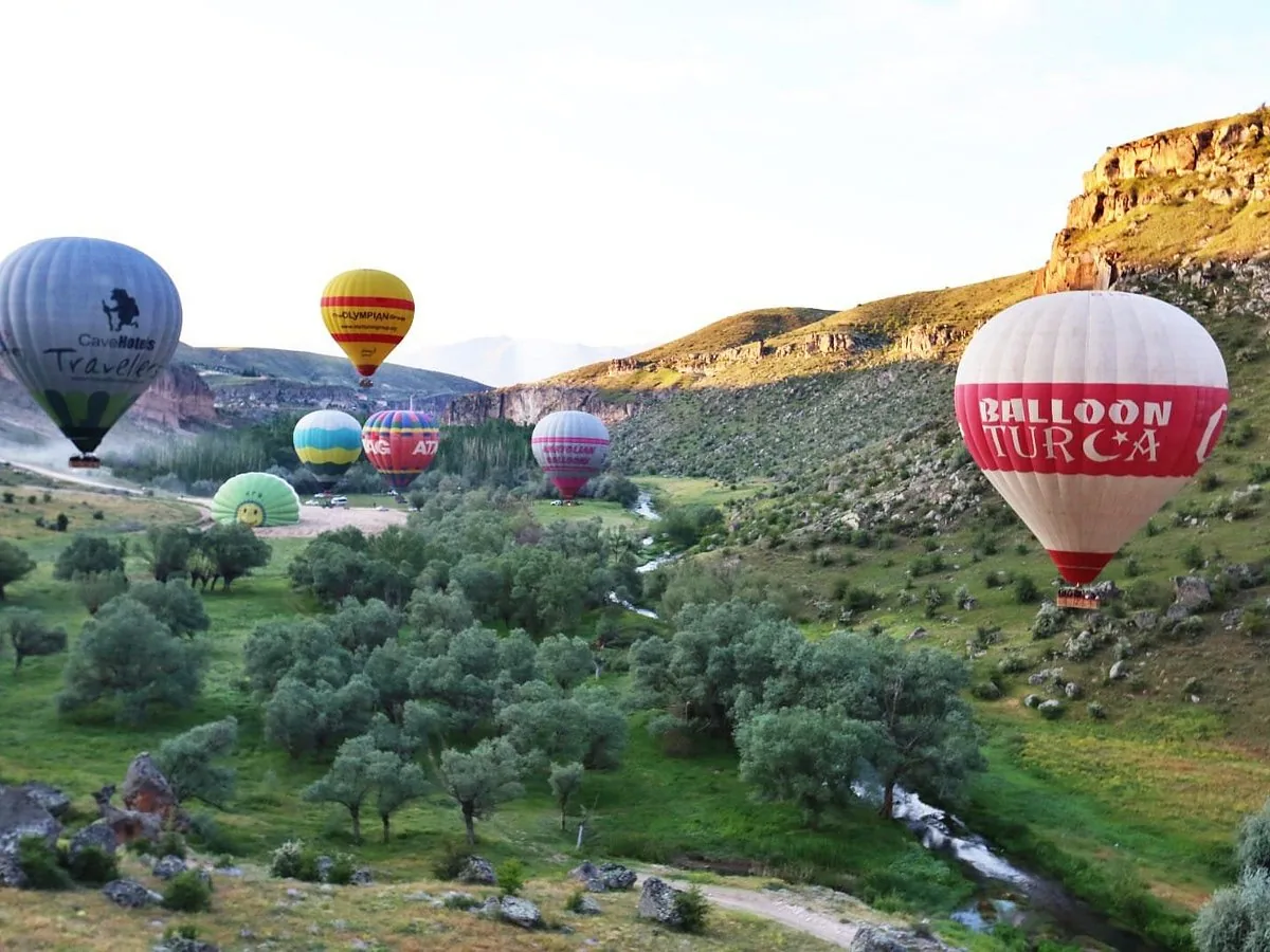 Hot air balloons floating through Ihlara Valley in Cappadocia