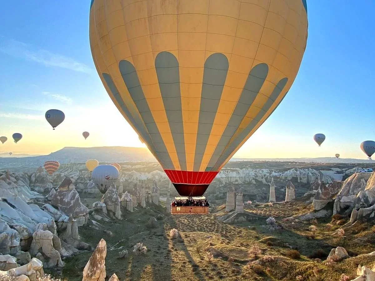 Private hot air balloon floating over Cappadocia fairy chimneys