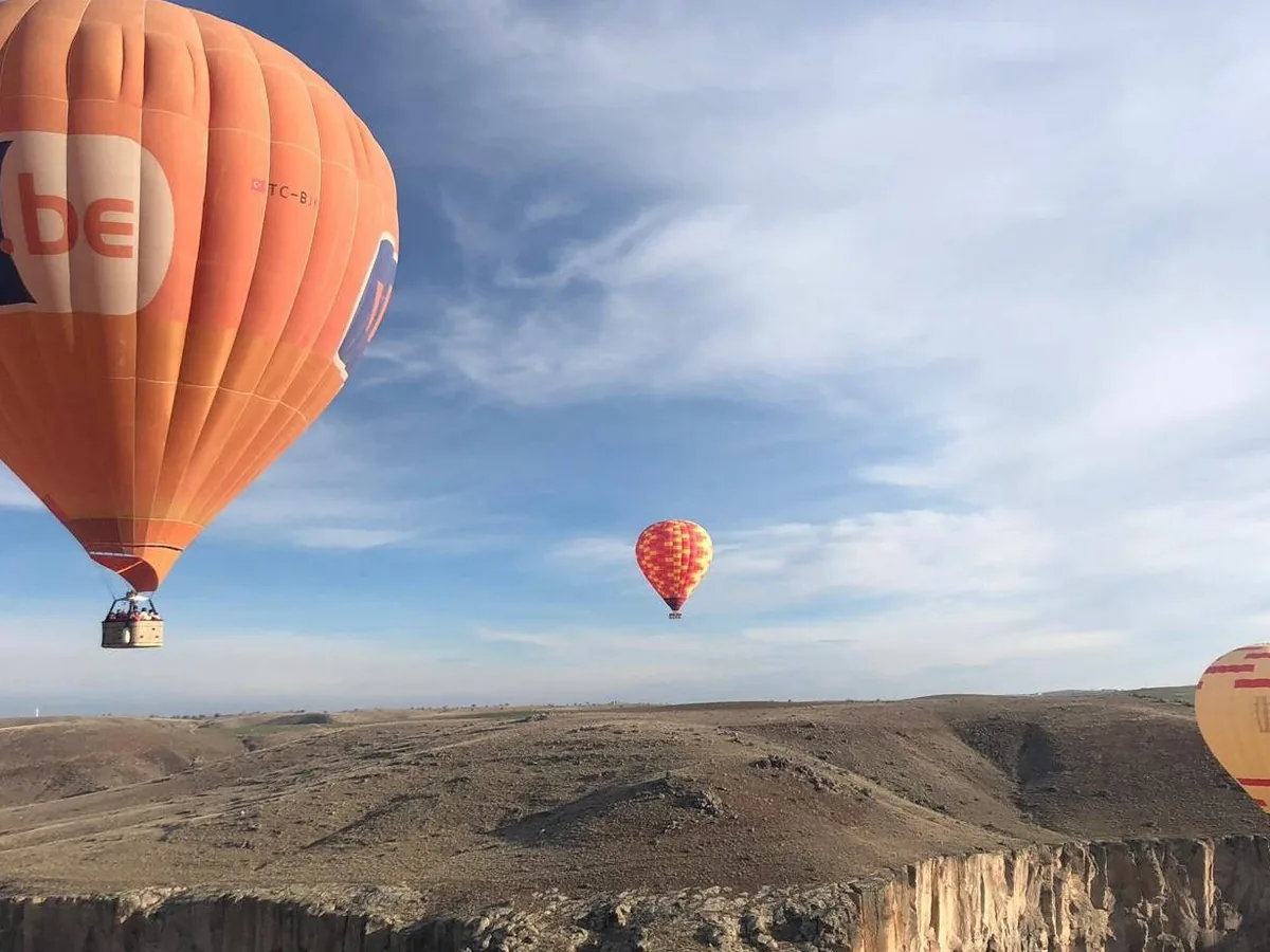 Scenic hot air balloons over Ihlara Valley landscape in Cappadocia