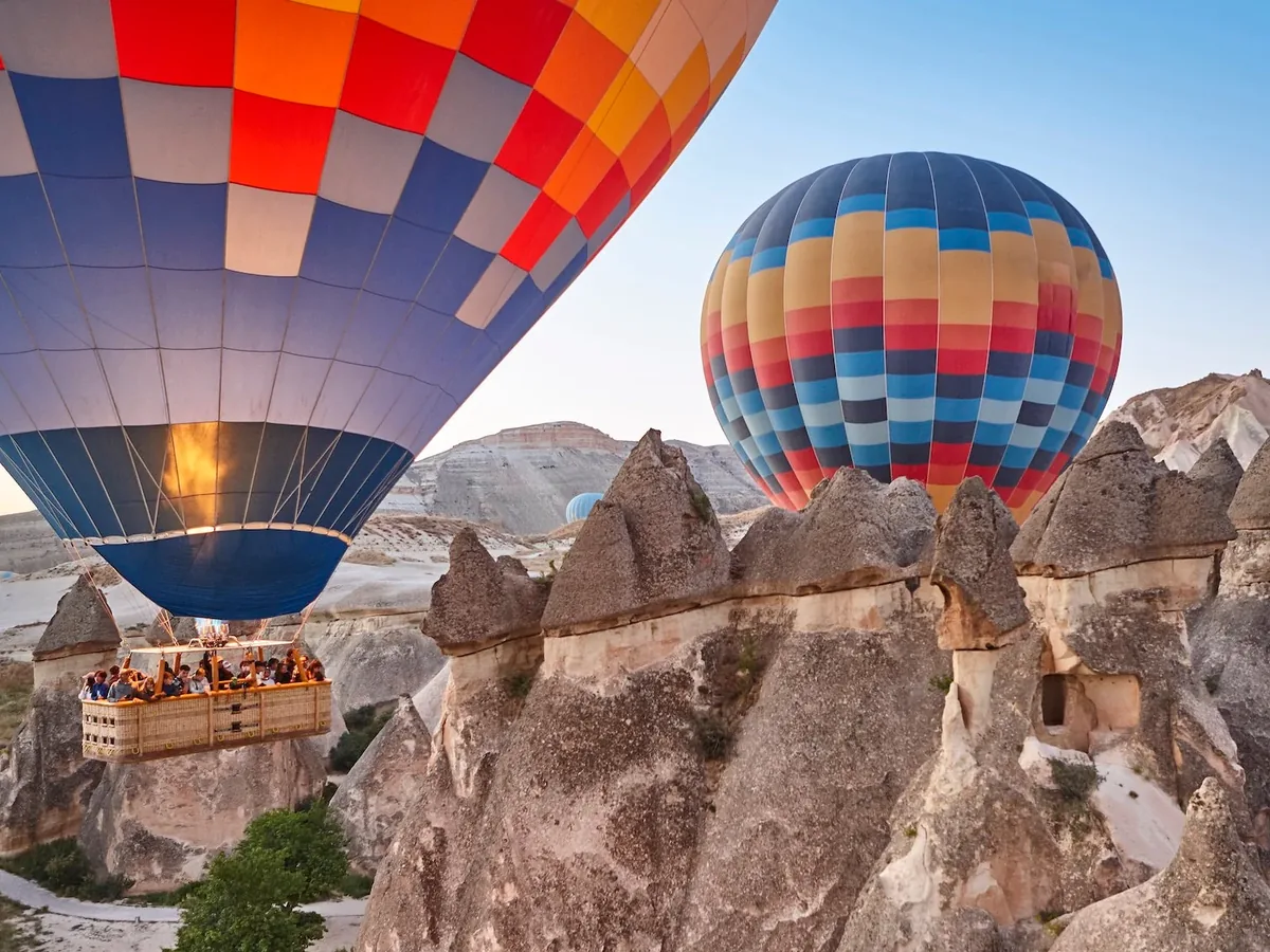 Spectacular hot air balloons floating close to fairy chimneys in Cappadocia