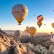 Sunrise hot air balloon flight among Cappadocia fairy chimneys