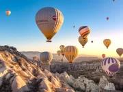 Sunrise hot air balloon flight among Cappadocia fairy chimneys