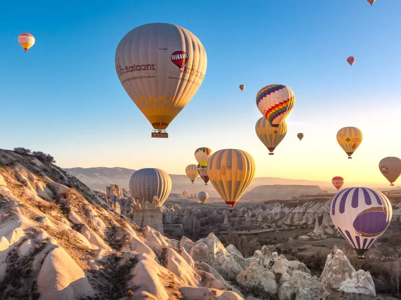 Sunrise hot air balloon flight among Cappadocia fairy chimneys