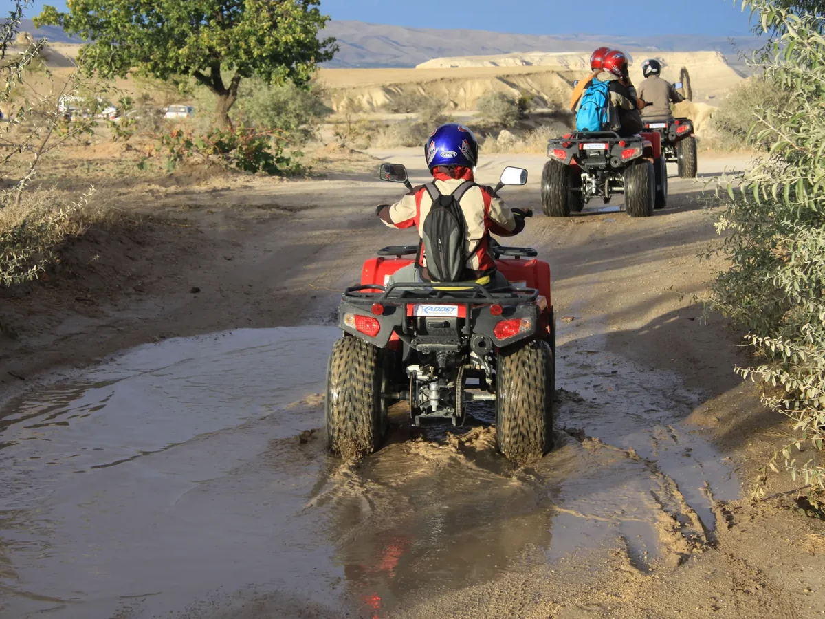 ATV riders following an off-road Cappadocia trail during the sunset tour