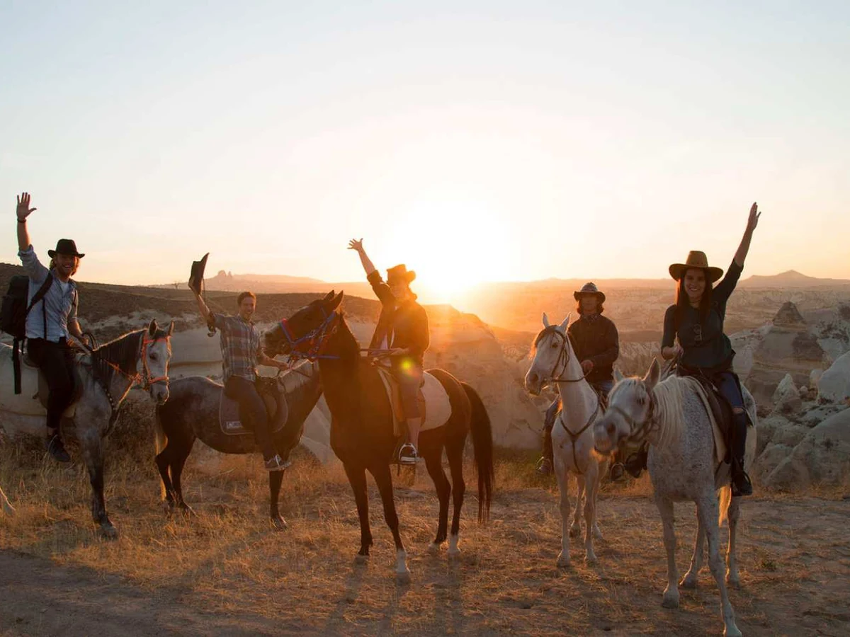 Riders on horseback enjoying golden-hour views in Cappadocia