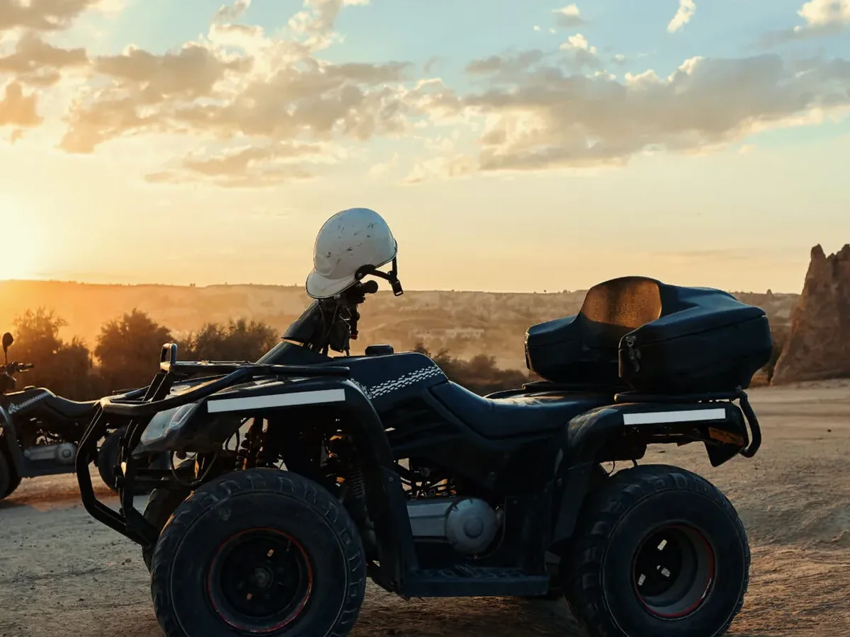 Quad bikes parked against a colorful Cappadocia sunset and fairy chimney view