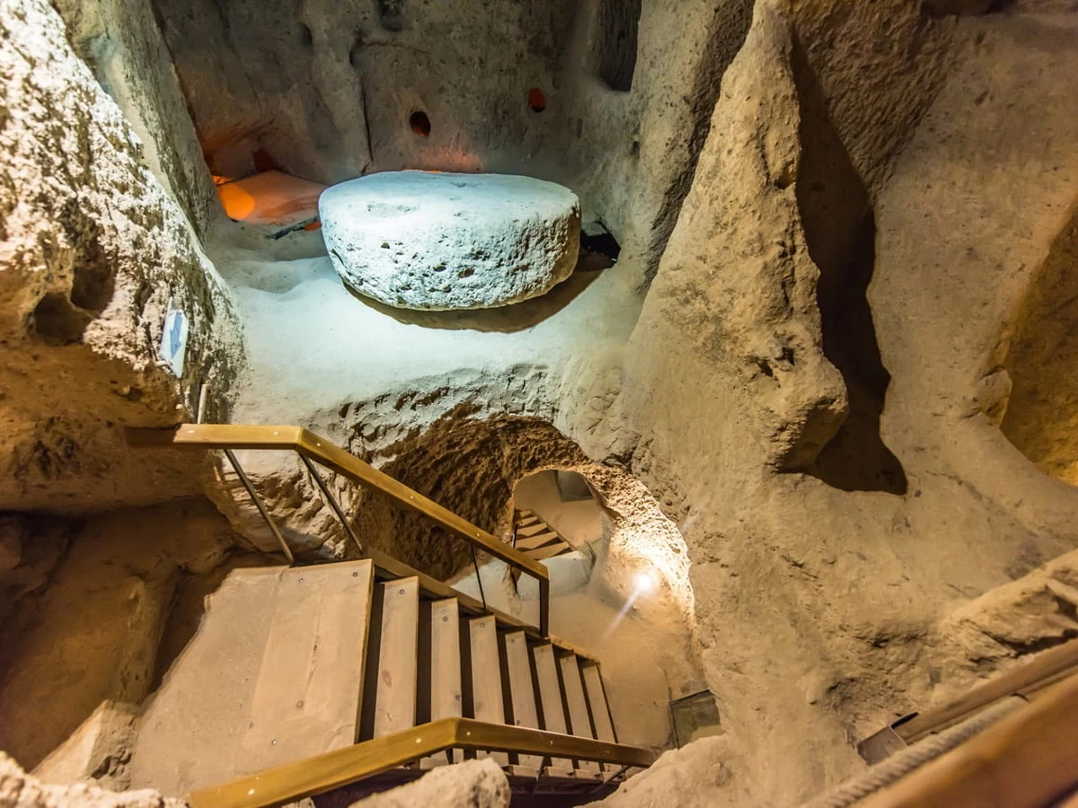 Stone millstone and passage inside a Cappadocia underground city on a private Green Tour